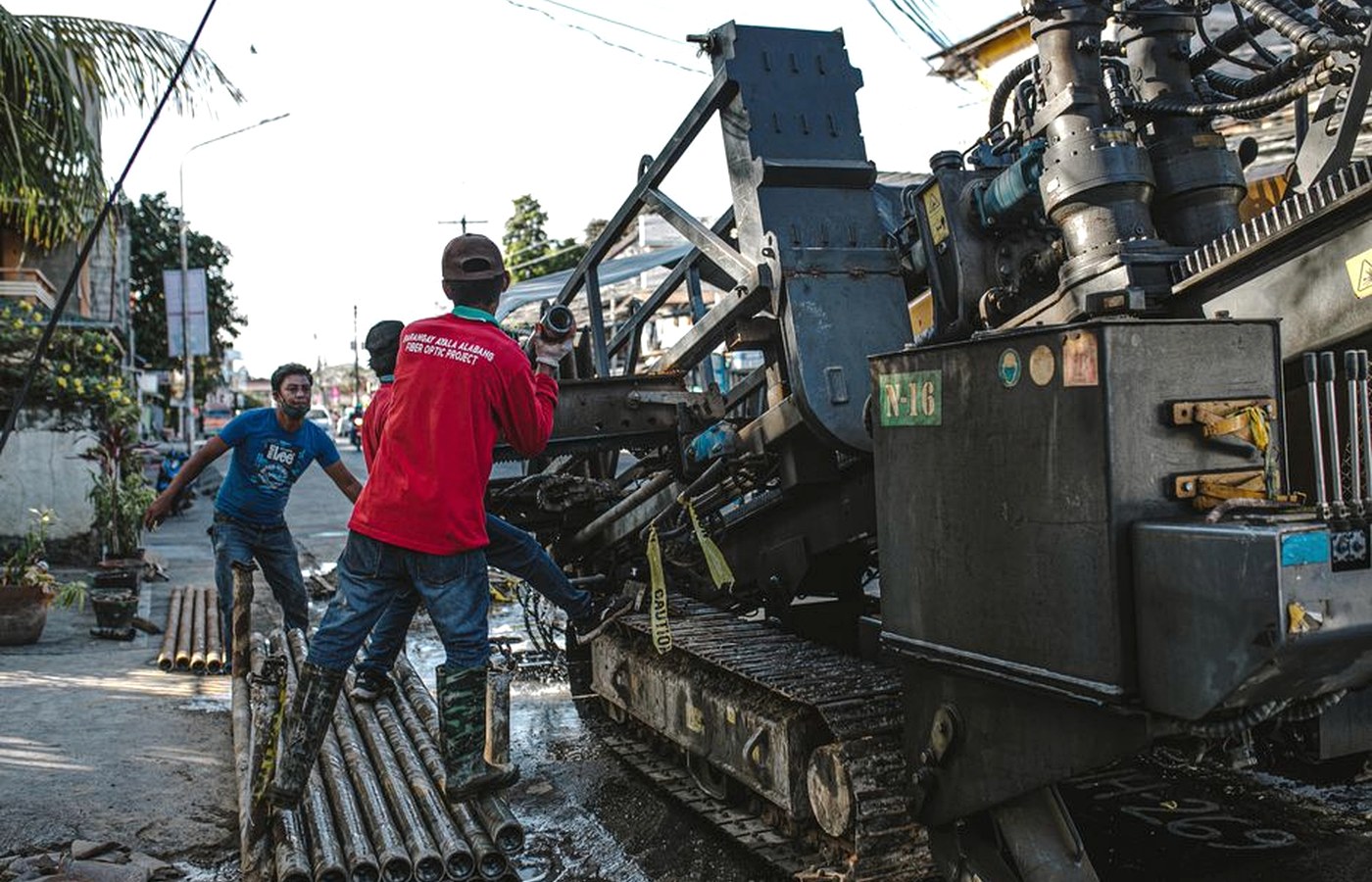 A street-level scene showing everyday work and the texture of an ordinary urban place.