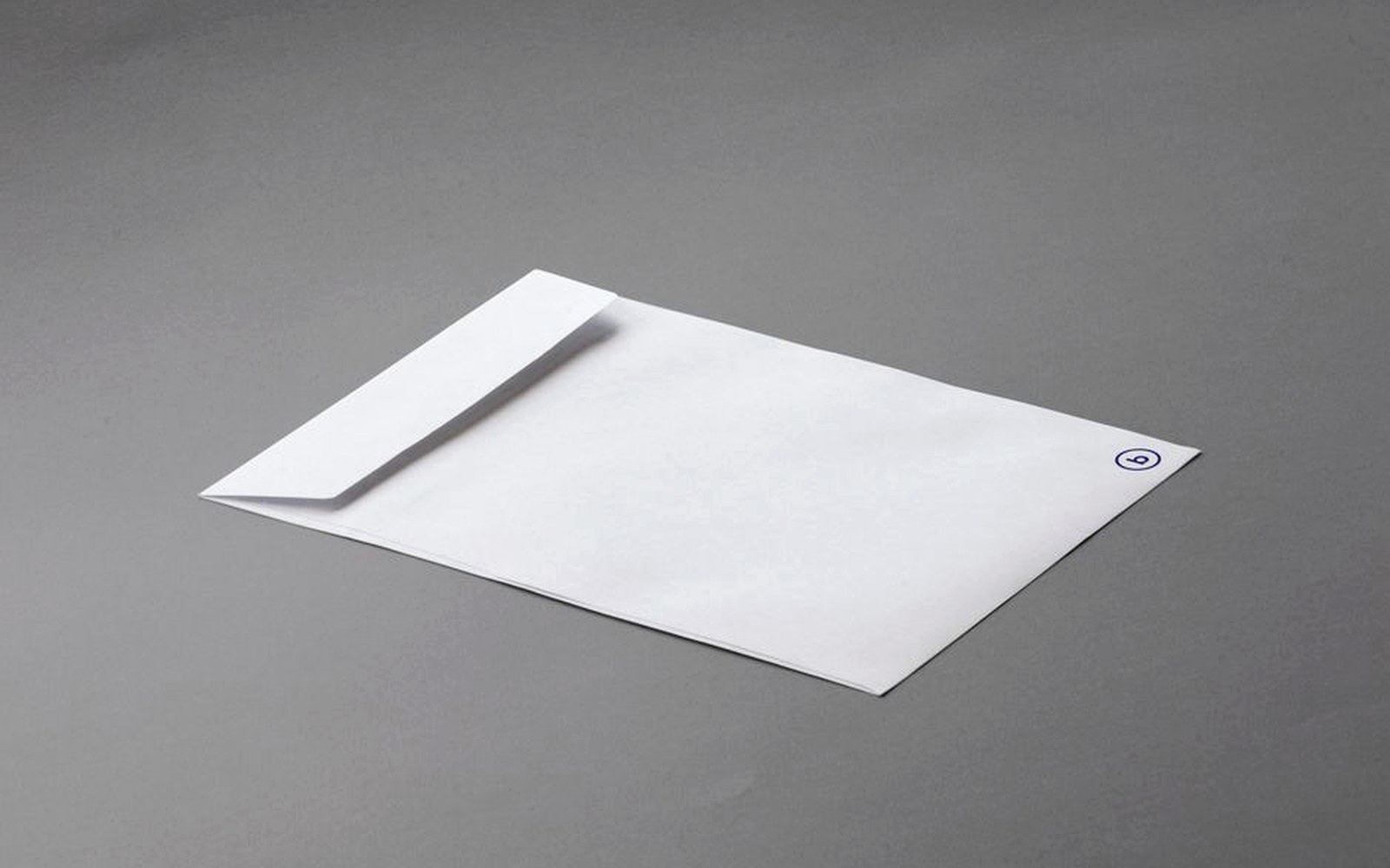 A white envelope on a simple gray surface.